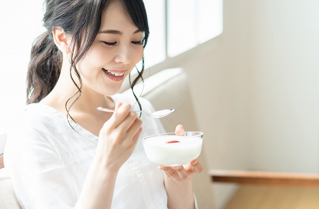 ヨーグルトを食べる女性